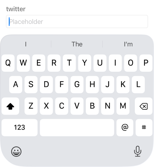 A partial screenshot of a keyboard on iPhone that displays all 26 letter keys in addition to the Shift, Delete, Numbers, Space, at symbol, and hash keys. Typing suggestions appear above the keyboard and the Emoji and Dictation buttons appear below it.
