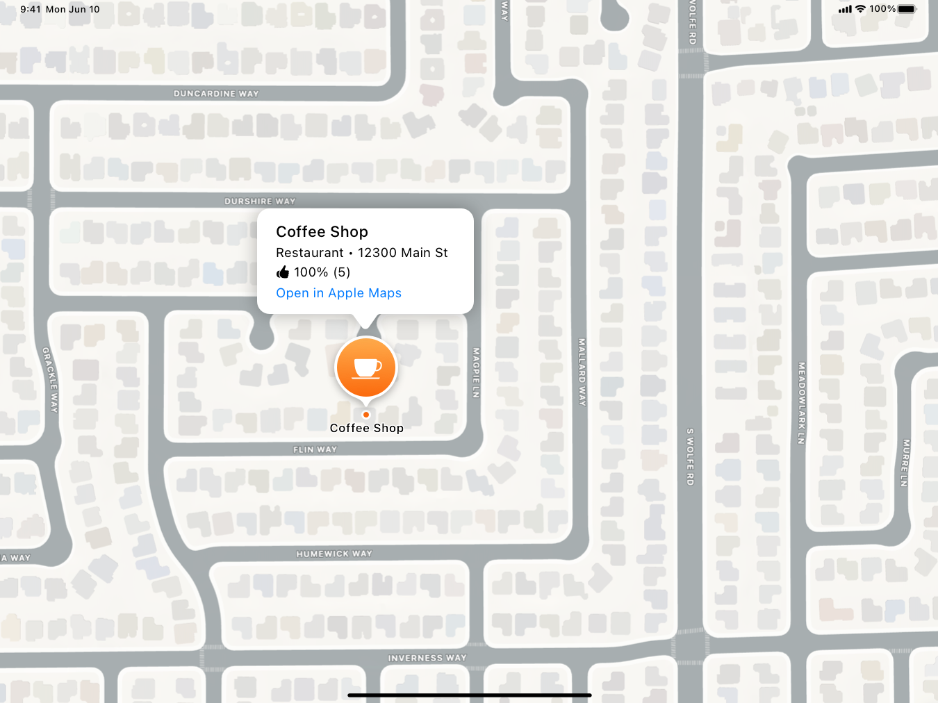 A screenshot of the compact callout style place card in a map on iPad. The place card includes the place name, category, shortened address, rating, and 'Open in Apple Maps' link.