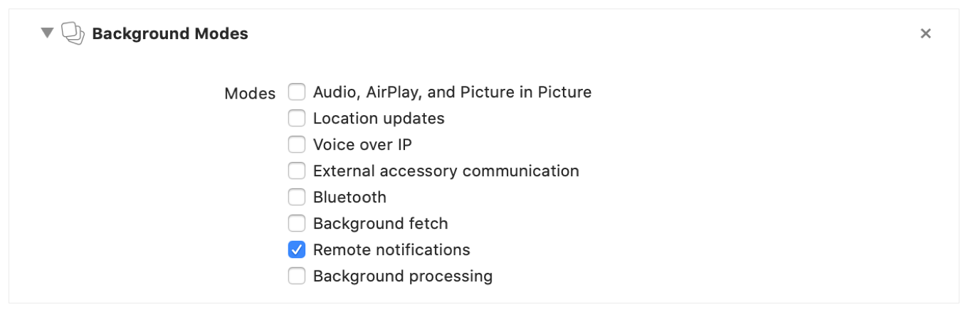 Screenshot showing the Background Modes section of the Signing & Capabilities tab with the Remote notifications checkbox selected.